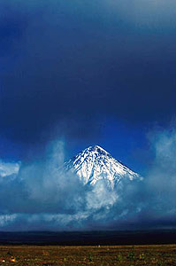 The peak of Kronotskaya Volcano in clouds.