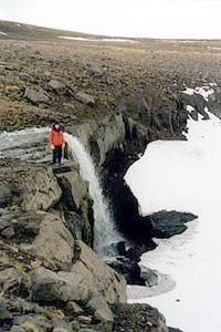 The waterfall into the ice sheet at Mutnovsky base camp.